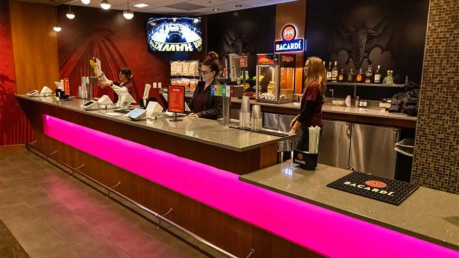 women behind serving counter smiling