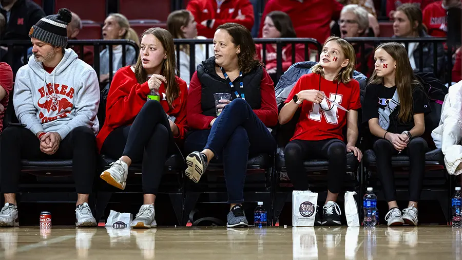 Fans sitting courtside wathcing the game