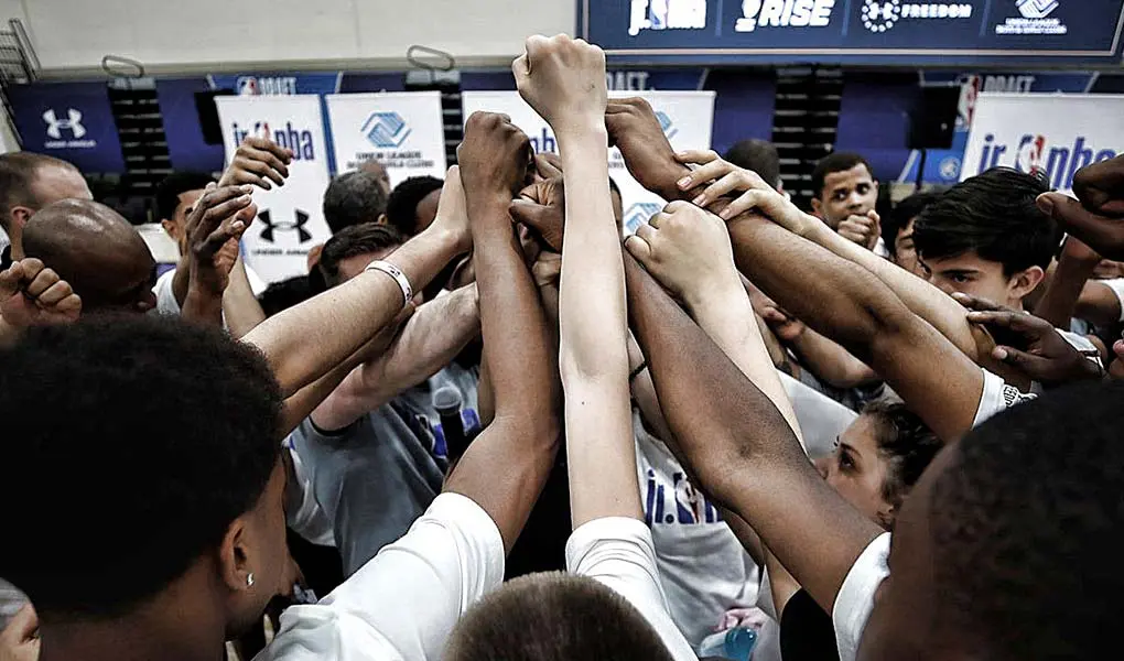 players in locker room huddle